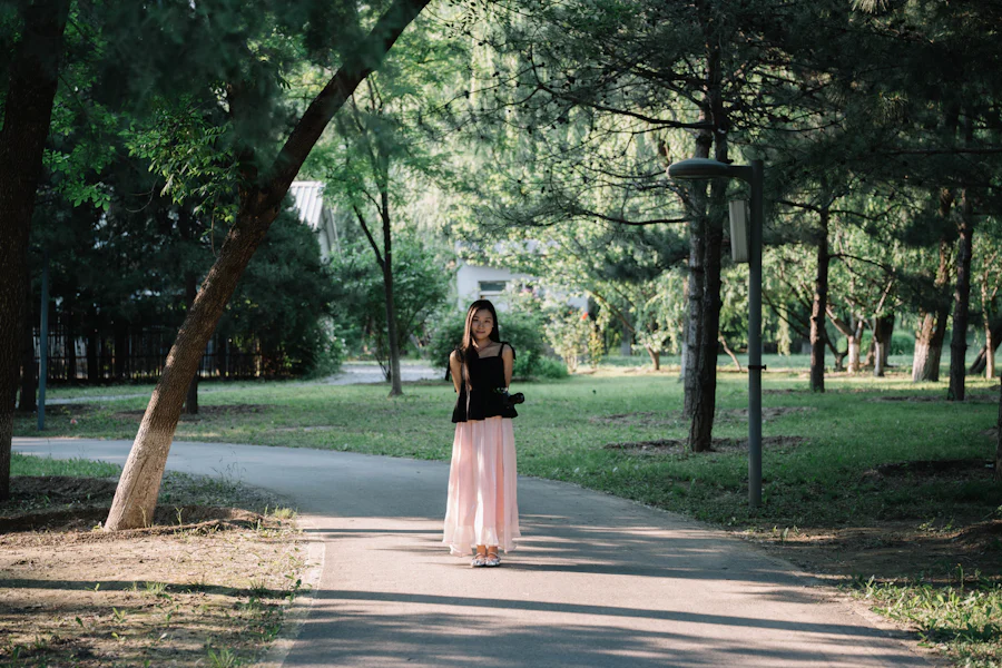 Woman walking along a sunlit park path